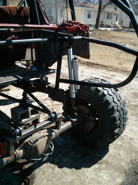 1986 Ford Bronco - Custom off-road vehicle chassis with heavy-duty suspension and large tires is shown from the side.