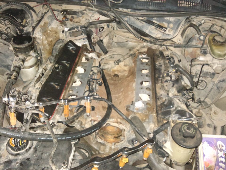 Engine bay with fuel injectors and intake manifold removed