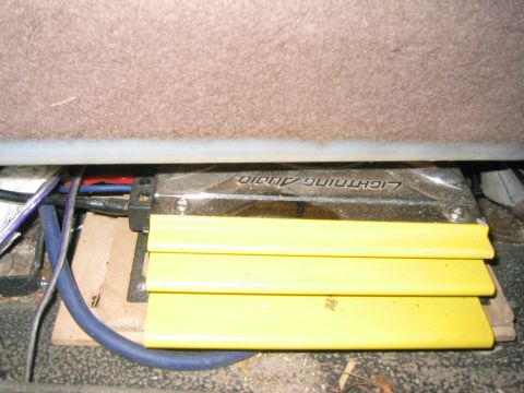 1996 Ford Bronco - A yellow car amplifier with 'Lightning Audio' branding is visible, installed beneath the vehicle's seat.