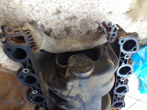 1998 Ford Crown Victoria - This engine intake manifold shows signs of wear and tear.