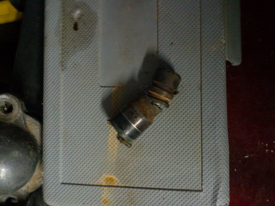 rusted metal part on textured surface