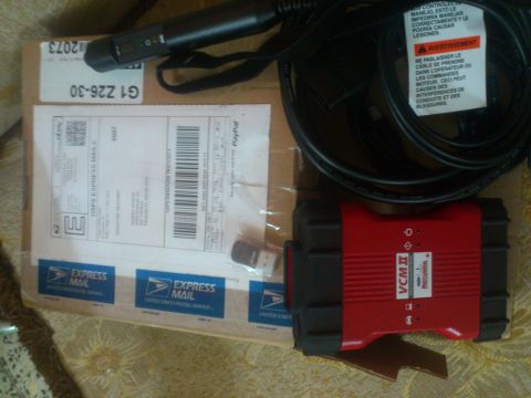 1998 Ford Crown Victoria - A VCM II diagnostic tool is shown with its cables and a USPS Express Mail shipping box.
