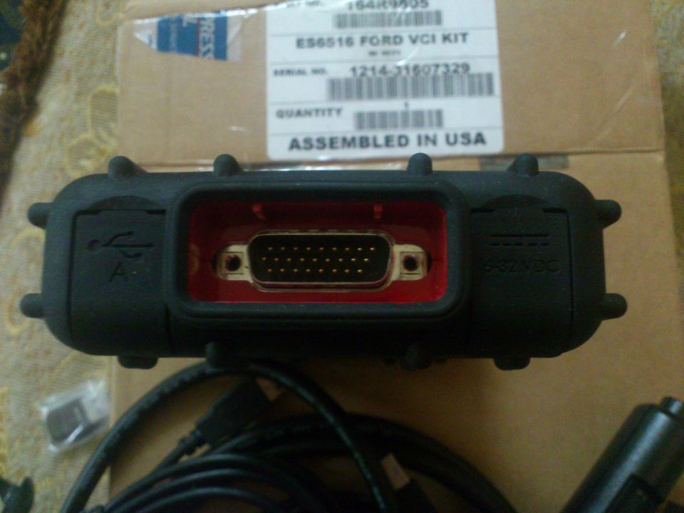 Ford VCI diagnostic tool with USB and 12V DC inputs, box in background reads ES6516 FORD VCI KIT