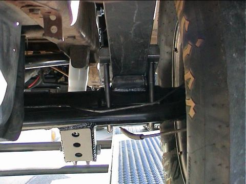 1979 Ford Bronco - Custom rear suspension bracket with three bolt holes, attached to a leaf spring and frame.