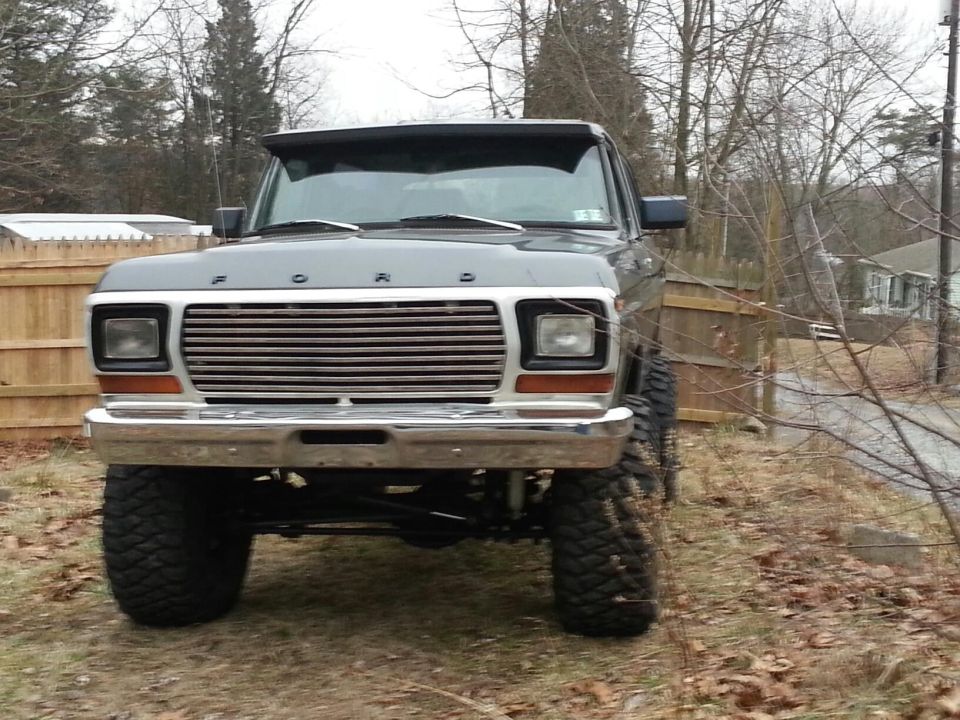 Front view of a lifted gray 1979 Ford F-Series truck with large tires