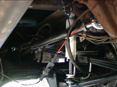 1979 Ford Bronco - Undercarriage view showing suspension parts including leaf springs and a shock absorber.