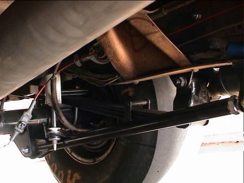 1979 Ford Bronco - Close-up of rear suspension parts, including leaf springs and shock absorbers.