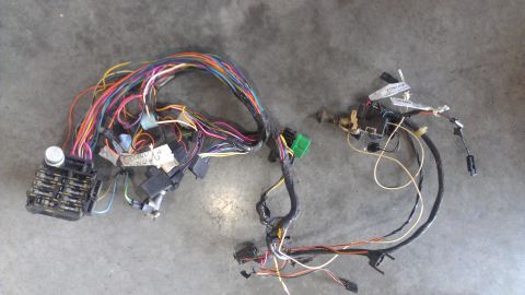 1973 Chevrolet Camaro - A complex wiring harness with multiple colored wires and connectors is laid out on a concrete floor.