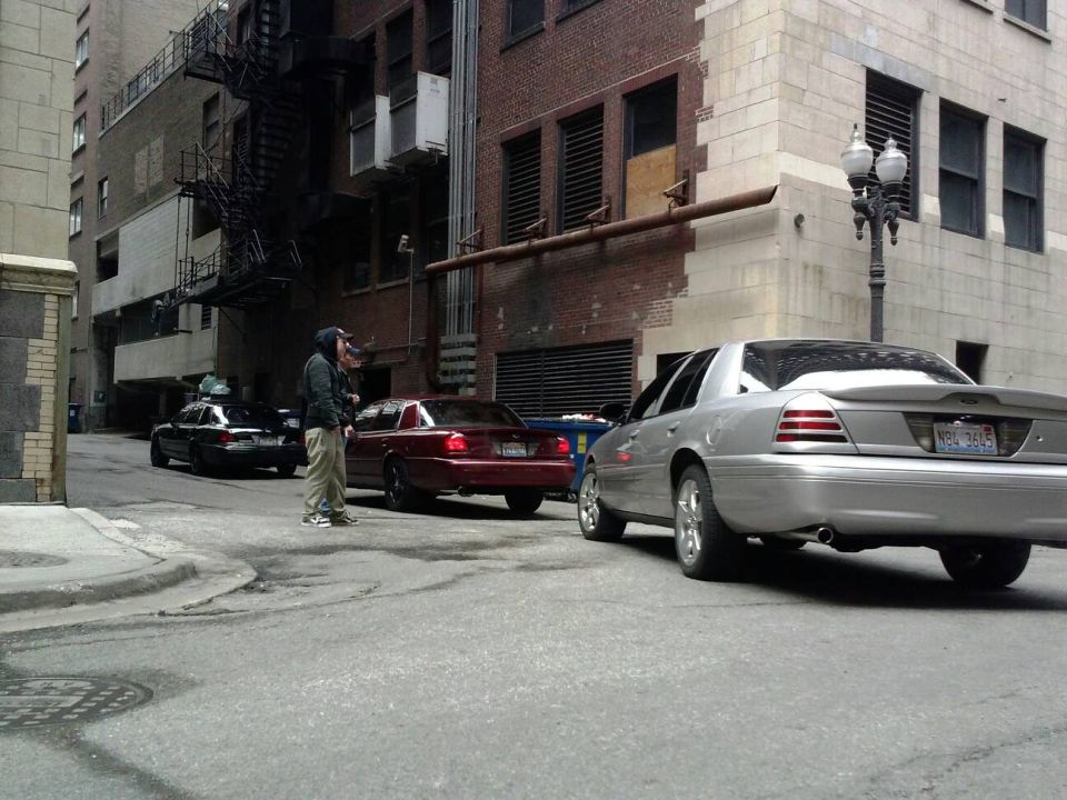 Silver 2003 Ford Crown Victoria rear view in alley. License plate NBW 3615