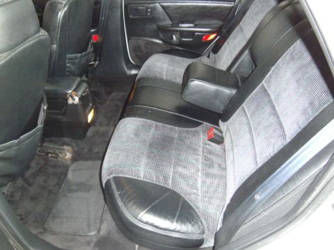 1992 Ford Taurus - The rear interior of a car, fabric and leather seats and a center console.
