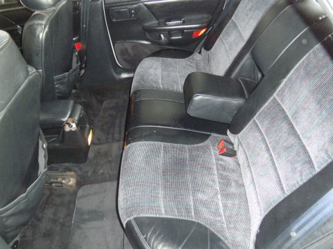 1992 Ford Taurus - The interior of the vehicle shows the rear seating area with fabric upholstery and black accents.