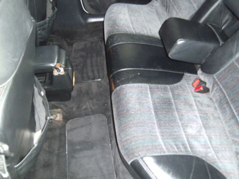 1992 Ford Taurus - Interior view of a car's back seat area, showing fabric upholstery and floor mats.
