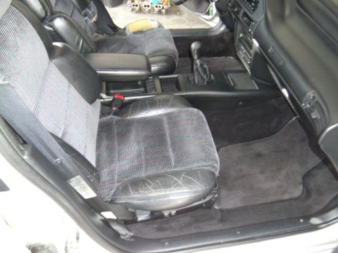 1992 Ford Taurus - Interior view showing front seats, center console, and dashboard of a car.