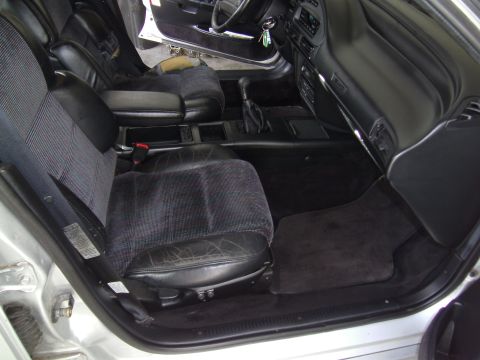 1992 Ford Taurus - The interior of a car is shown, dark upholstery and the dashboard area.