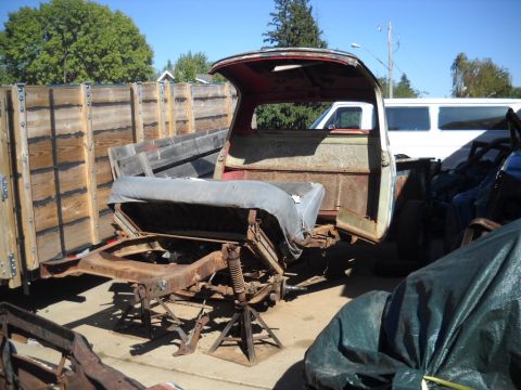 1954 Ford F-100 - Disassembled 1954 Ford F-100 truck cab and chassis sits outdoors on jack stands.