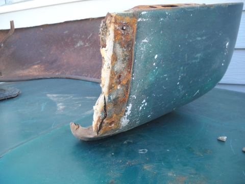 1954 Ford F-100 - A heavily corroded automotive part, likely from a vintage vehicle, displays extensive rust and damage.