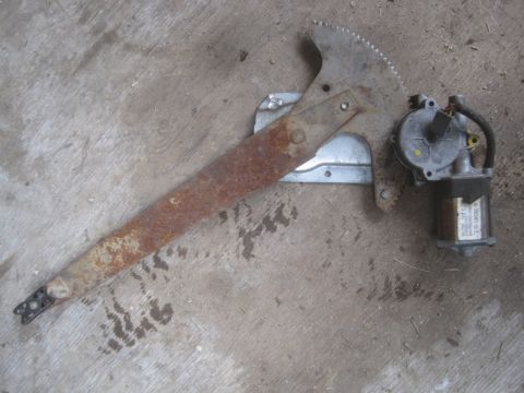 1993 Ford Bronco - Power window regulator motor assembly shown on a concrete surface.