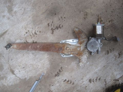 1993 Ford Bronco - This is a power window regulator motor assembly, showing significant rust and wear.