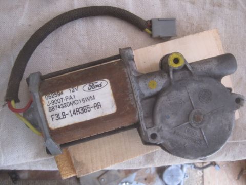 1993 Ford Bronco - A Ford window regulator motor is shown with its part number and voltage rating visible.