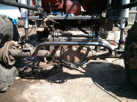 1986 Ford Bronco - The rear axle and suspension components of a custom-built off-road vehicle are shown in this close-up view.