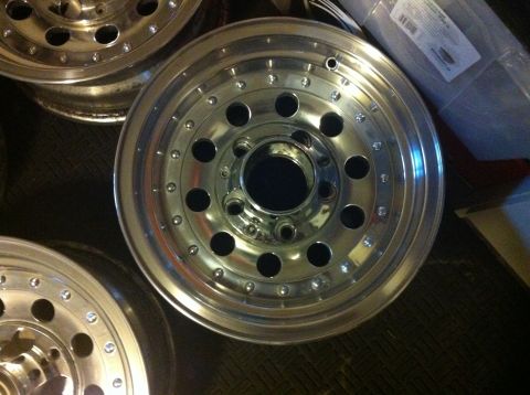 1992 Ford F-150 - Close-up view of several shiny aluminum alloy wheels, some stacked and partially visible.