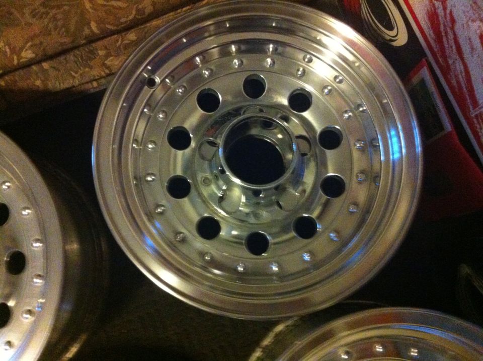 Polished aluminum five-lug truck wheel with beadlock-style bolt ring, face-on