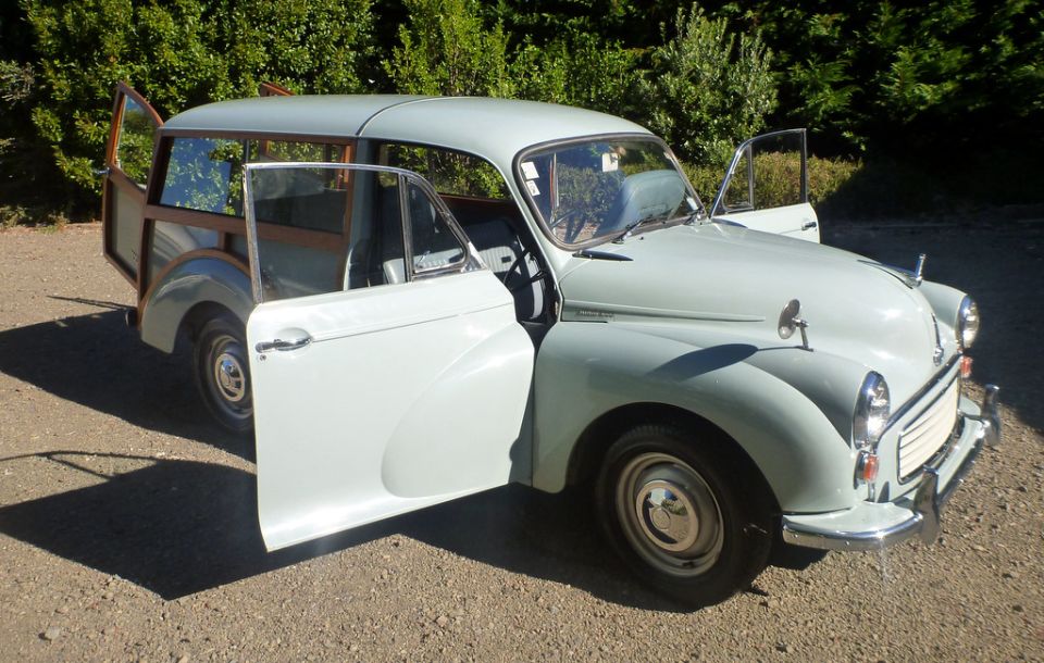 Light blue woody station wagon, front 3/4 view with doors open