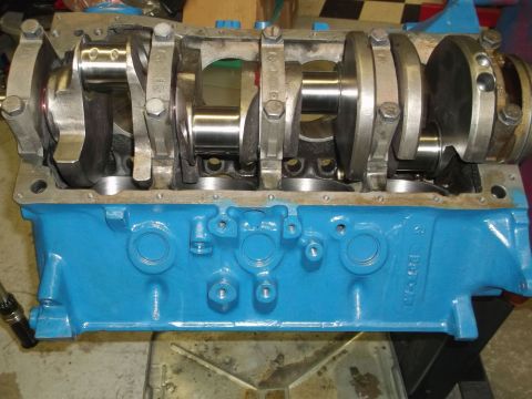 1970 Ford Mustang - Close-up view of an engine block with a crankshaft installed, painted bright blue.