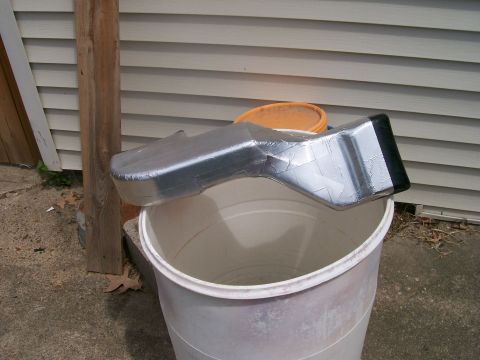 1990 Ford F-150 - Custom air intake duct made from aluminum and tape, placed on a bucket outdoors.
