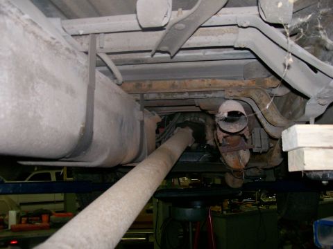 1990 Ford F-150 - The underside of a truck is visible, including the fuel tank, driveshaft, and exhaust components.