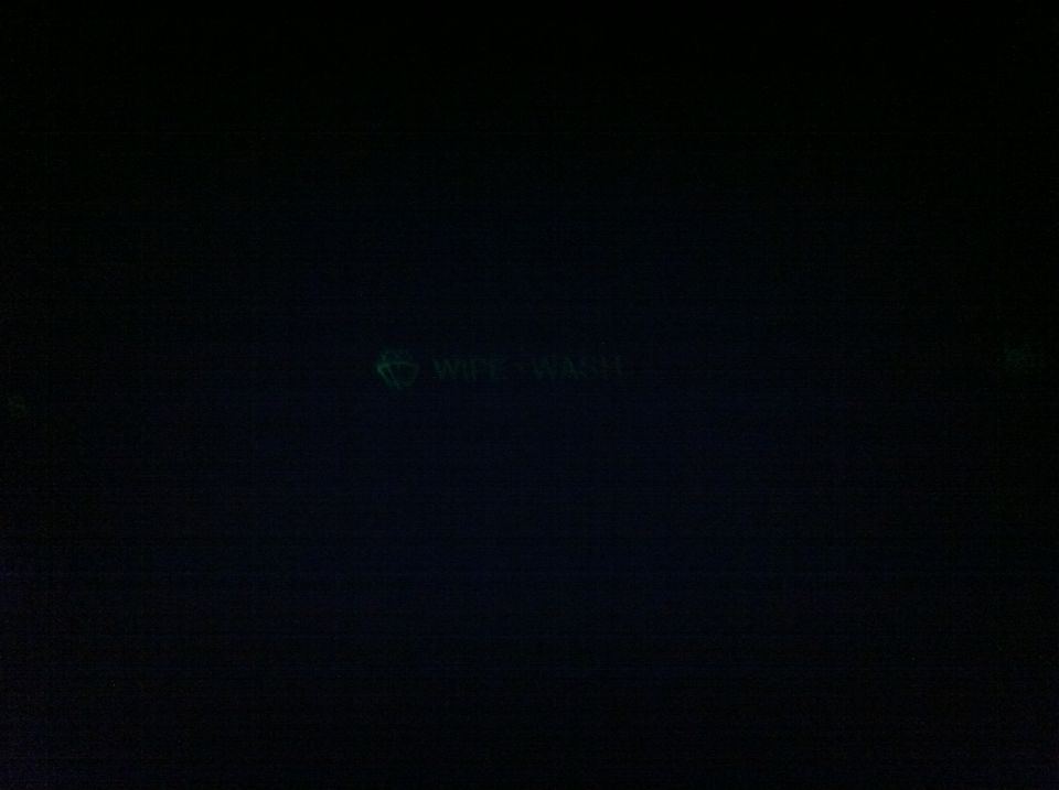 Dark dashboard display showing a green WIPE WASH indicator