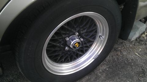 2000 Mercury Grand Marquis - A close-up view of a car's wheel and tire, a distinctive mesh spoke design.