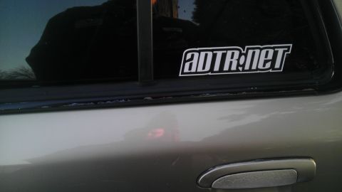 2000 Mercury Grand Marquis - A close-up view of a car's side panel and window, showing a sticker and a watermark.