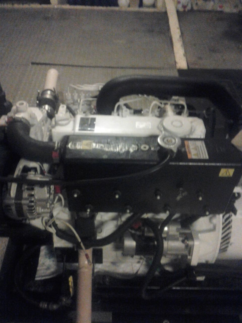 engine with black and white components, hoses, and wires