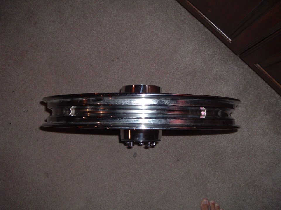 Chrome motorcycle wheel with spokes visible on hub