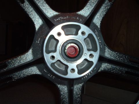 2002 Harley-Davidson Sportster Custom - A close-up view of a motorcycle wheel's central hub assembly, showing the bearing and mounting points.