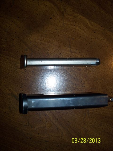 2000 Nissan Xterra - Two gun magazines are displayed on a wooden table. The image includes a date stamp of 03/28/2013.