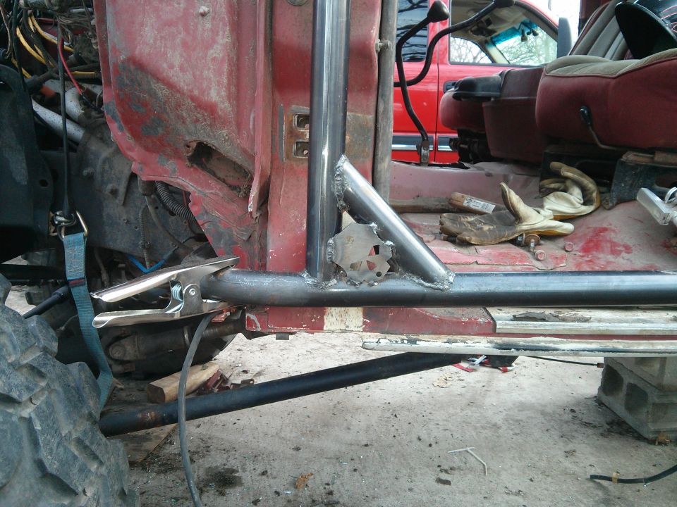 Red SUV interior with roll cage and a second red vehicle visible