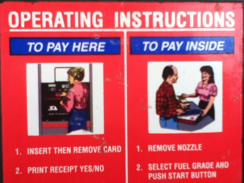 2006 Ford E350 - Sign shows operating instructions for paying at a gas station, with separate steps for paying at the pump or inside.