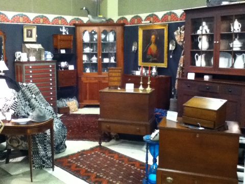 2006 Ford E350 - An antique furniture display features various wooden pieces like cabinets, chests, and a dresser.