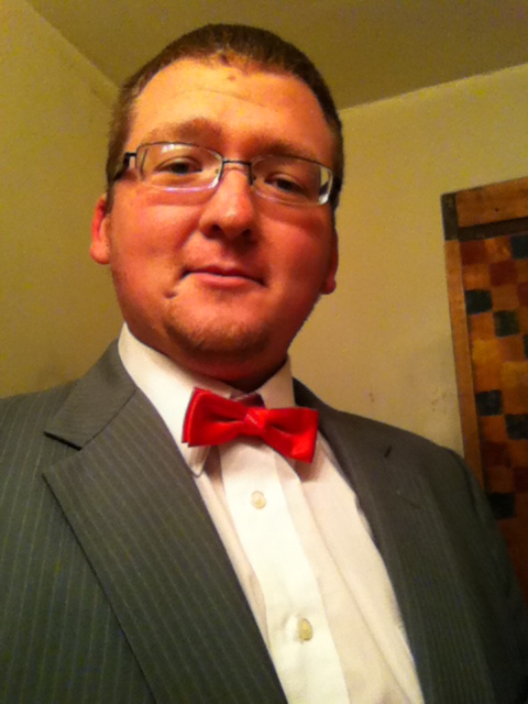 2006 Ford E350 - A man in formal attire poses for a selfie, looking directly at the camera.