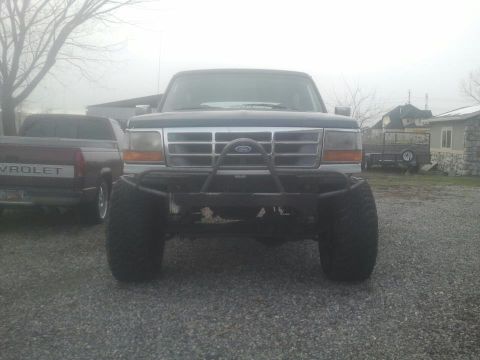 1994 Ford Bronco - This 1994 Ford Bronco is presented with a custom front bumper and large off-road tires.