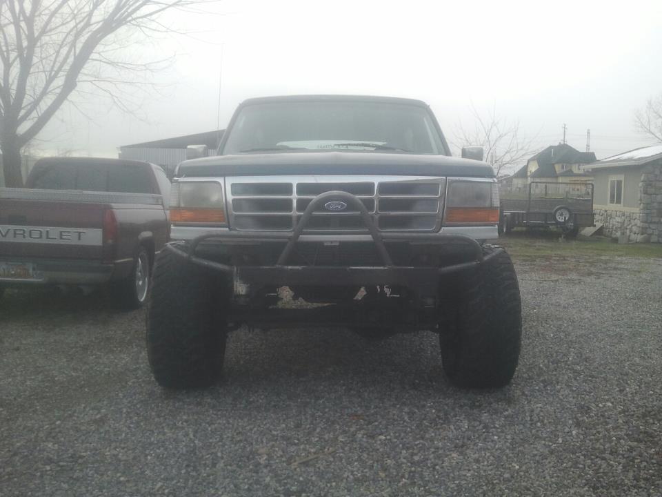 Front view of a 1994 Ford Bronco with a custom bumper and large tires