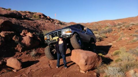 1994 Ford Bronco - This 1994 Ford Bronco is navigating a challenging off-road course in a desert landscape.