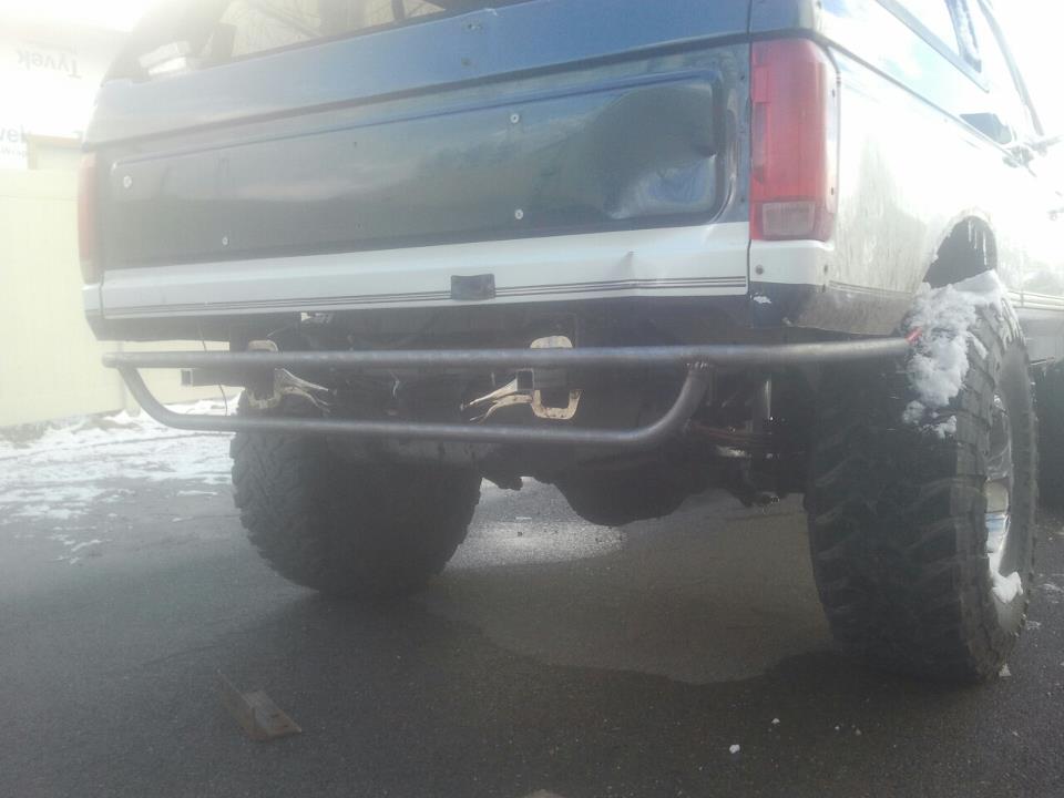 Rear view of a 1992 Ford Bronco with a custom bumper and large tires
