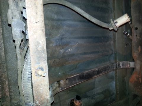 1994 Ford Bronco - Underside of vehicle chassis with fuel lines and frame components visible.