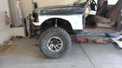 1994 Ford Bronco - This Ford Bronco appears to be undergoing repairs or modifications in a garage setting.