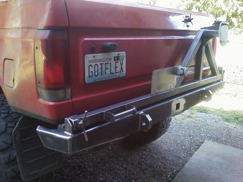 1989 Ford Bronco - Rear view of a 1989 Ford Bronco showing a custom bumper and spare tire carrier. Washington plate reads GOTFLEX.