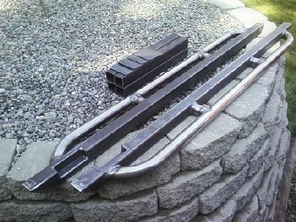 1989 Ford Bronco - Custom metal running boards and square tubing are displayed on a stone wall.