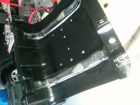 1994 Ford Bronco - Close-up view of a black metal fuel tank, showing welds and mounting points.